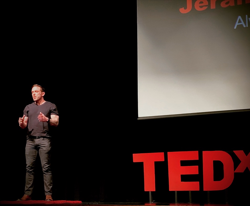 Jeramiah Solven speaking on a TEDx stage